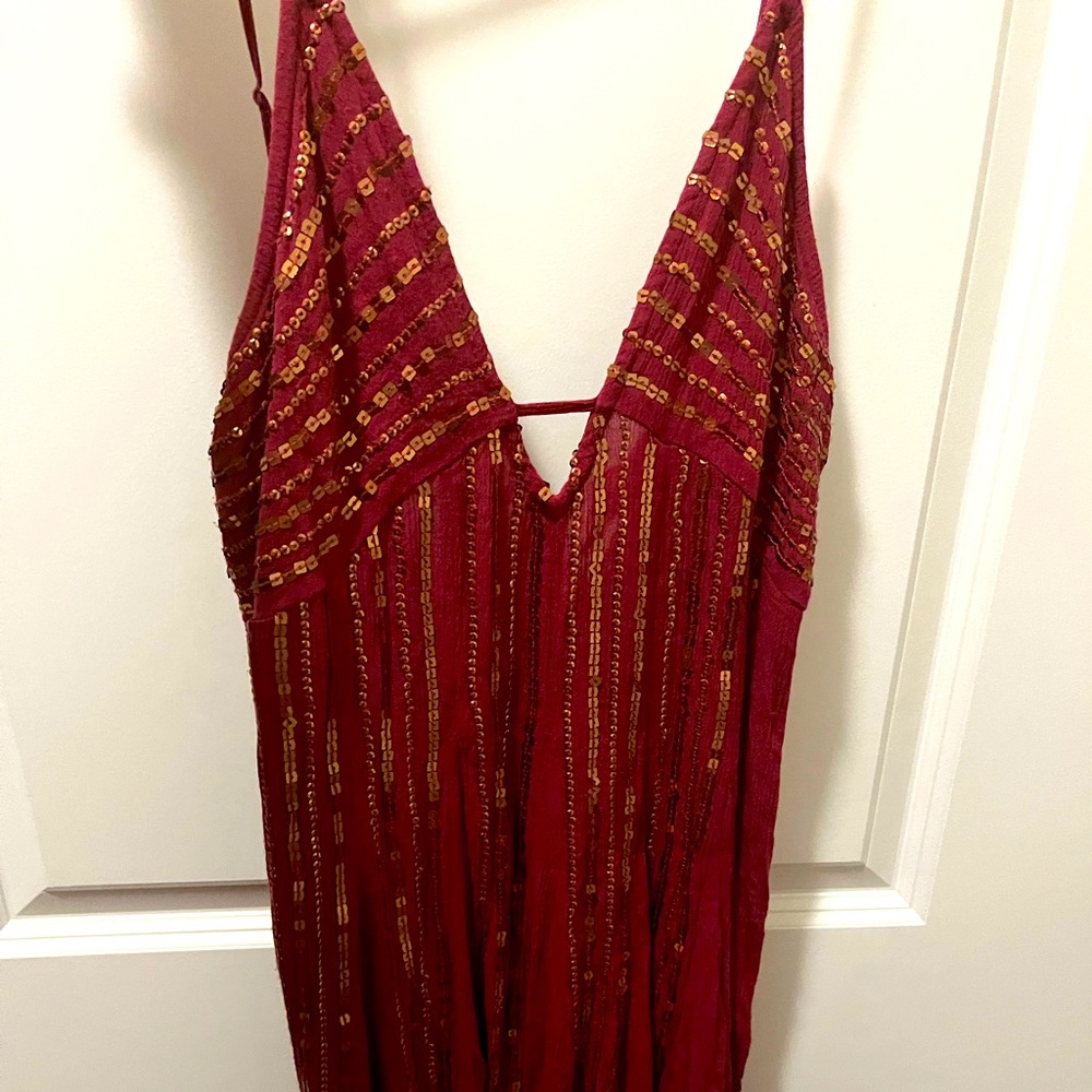 Low cut mini dress with gold sequins. Beautiful and flattering. True to size